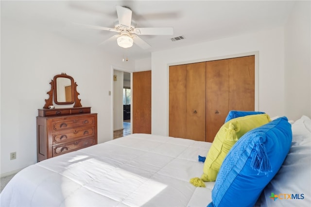 carpeted bedroom featuring a closet and ceiling fan