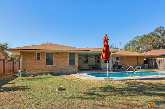 rear view of house featuring a lawn, a patio area, and ceiling fan