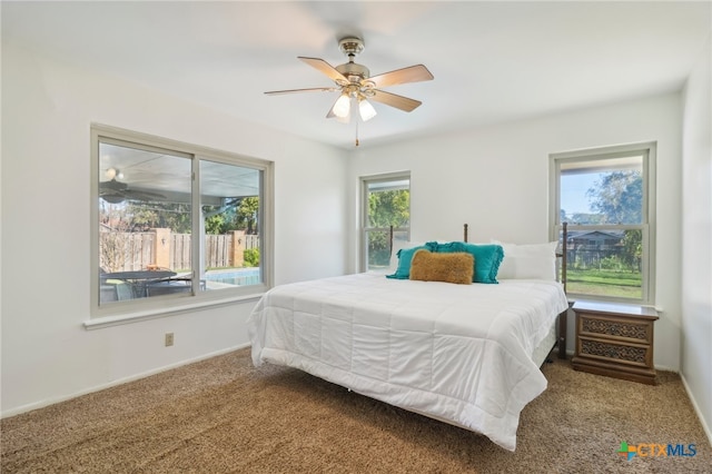 bedroom featuring carpet flooring, ceiling fan, and multiple windows