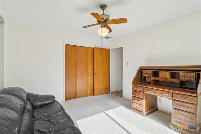 office with light colored carpet and ceiling fan