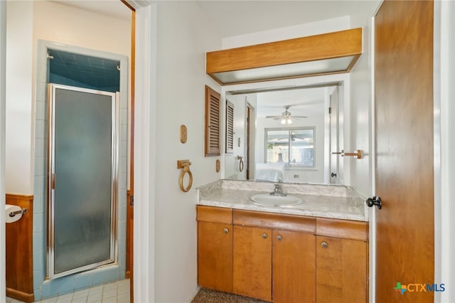 bathroom featuring ceiling fan, a shower with door, and vanity