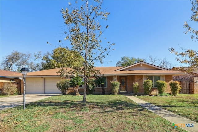 ranch-style home with a front lawn and a garage