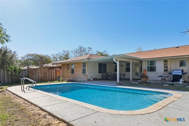 view of swimming pool featuring a patio area and area for grilling