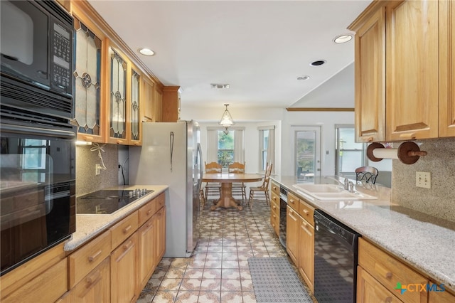 kitchen with sink, backsplash, plenty of natural light, and black appliances