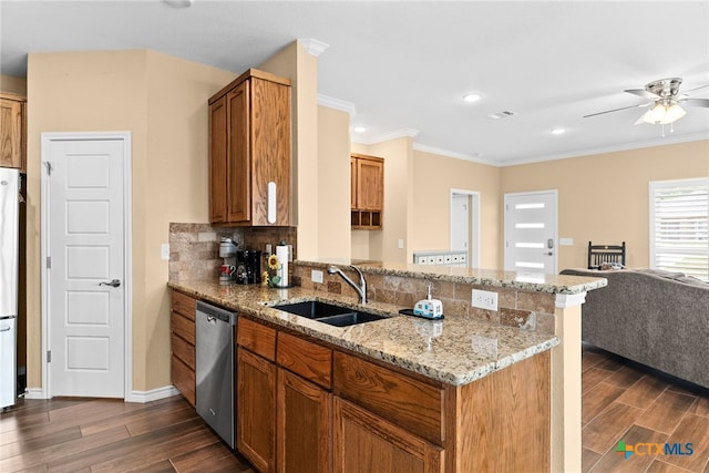 kitchen featuring dark hardwood / wood-style flooring, light stone countertops, sink, stainless steel dishwasher, and kitchen peninsula