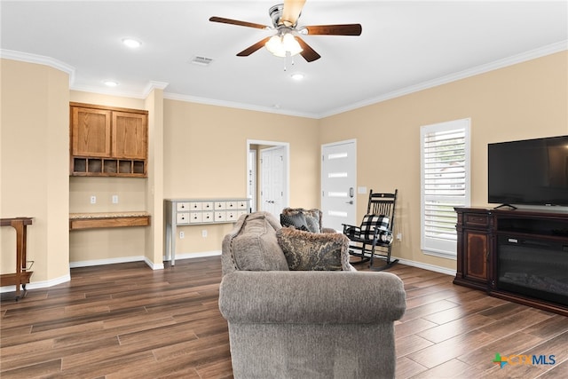 living room featuring dark wood-type flooring, ceiling fan, and crown molding