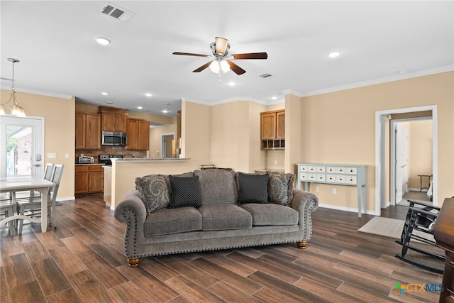 living room with crown molding, dark hardwood / wood-style floors, and ceiling fan