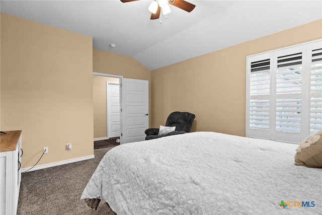 bedroom with ceiling fan, dark colored carpet, and lofted ceiling