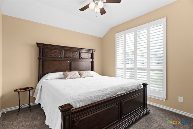 bedroom featuring ceiling fan, dark colored carpet, and vaulted ceiling