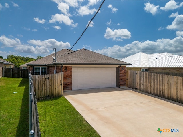 view of front of property with a front yard and a garage