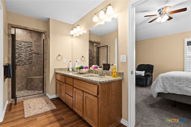 bathroom featuring an enclosed shower, vanity, hardwood / wood-style flooring, and ceiling fan