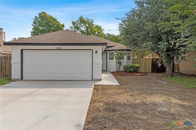 1701 Southwestern Trl, Round Rock, TX 78664 - ranch-style home featuring driveway, an attached garage, roof with shingles, and brick siding