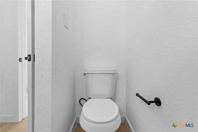 1701 Southwestern Trl, Round Rock, TX 78664 - bathroom featuring toilet, wood finished floors, baseboards, and a textured wall