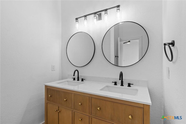 1701 Southwestern Trl, Round Rock, TX 78664 - bathroom featuring double vanity and a ceiling fan