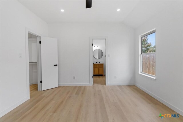 1701 Southwestern Trl, Round Rock, TX 78664 - unfurnished bedroom featuring a spacious closet, light wood-type flooring, baseboards, recessed lighting, and ensuite bathroom