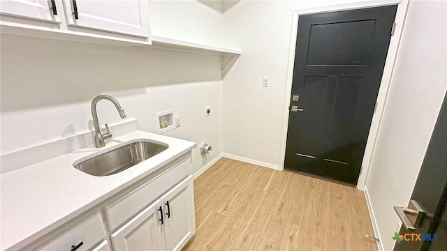 1486 Walker Place Blvd, Copperas Cove, TX 76522 - clothes washing area featuring light wood-style flooring, washer hookup, a sink, cabinet space, and electric dryer hookup