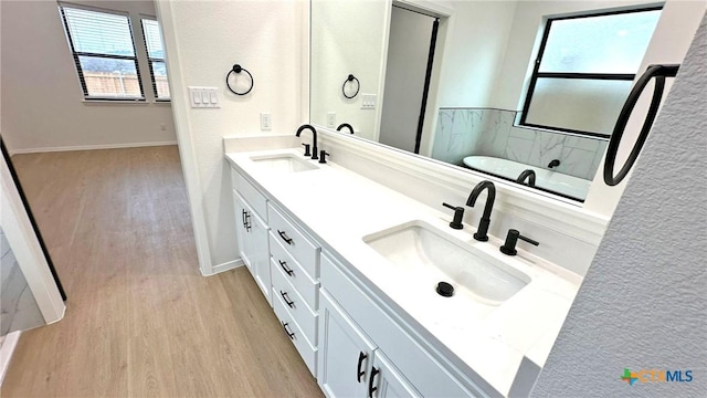 1486 Walker Place Blvd, Copperas Cove, TX 76522 - full bathroom featuring double vanity, a sink, and wood finished floors