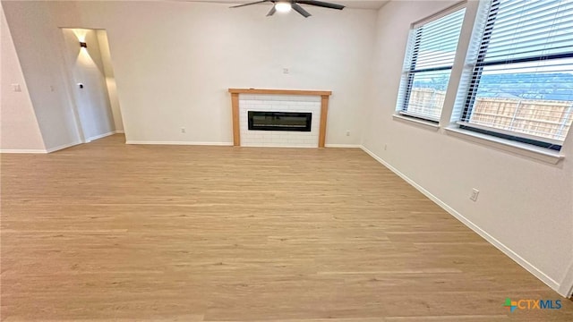 1486 Walker Place Blvd, Copperas Cove, TX 76522 - unfurnished living room with baseboards, a fireplace, a ceiling fan, and light wood-style floors