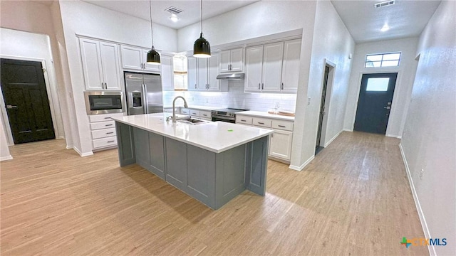 1486 Walker Place Blvd, Copperas Cove, TX 76522 - kitchen with visible vents, appliances with stainless steel finishes, light wood-style floors, a sink, and under cabinet range hood