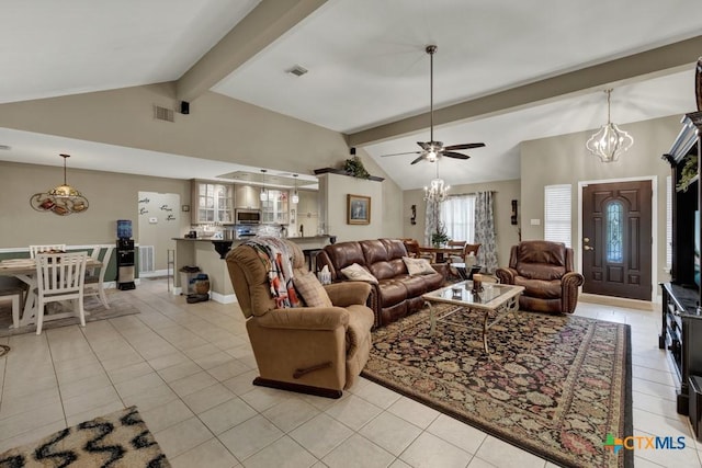 living room with ceiling fan with notable chandelier, light tile patterned flooring, lofted ceiling with beams, and visible vents