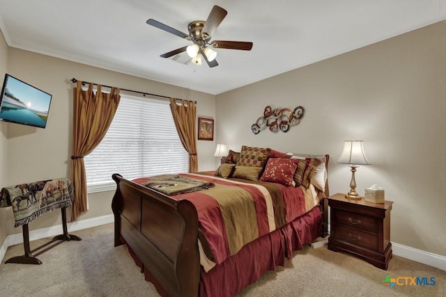 bedroom featuring light carpet, a ceiling fan, and baseboards