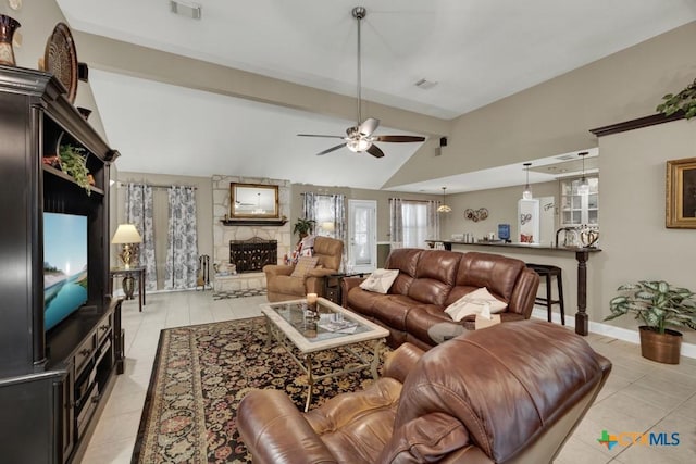 living area with light tile patterned flooring, lofted ceiling with beams, a ceiling fan, and visible vents