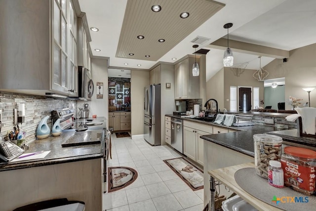 kitchen featuring tasteful backsplash, light tile patterned floors, glass insert cabinets, stainless steel appliances, and a sink