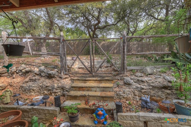 view of yard with fence and a gate