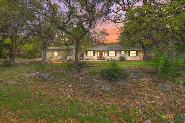 ranch-style house featuring a yard