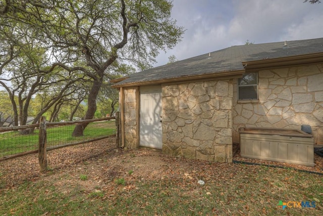 view of outbuilding with fence