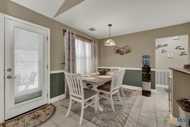 dining room featuring baseboards, visible vents, and light tile patterned flooring