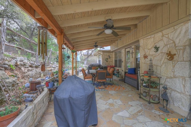 view of patio featuring area for grilling, outdoor dining space, and ceiling fan