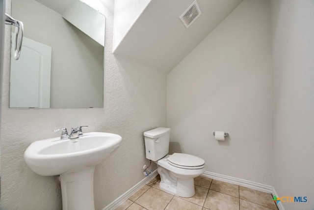 2241 Windswept Way, New Braunfels, TX 78132 - half bathroom with toilet, tile patterned floors, baseboards, and a sink