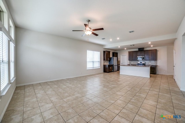 2241 Windswept Way, New Braunfels, TX 78132 - unfurnished living room with light tile patterned floors, recessed lighting, a ceiling fan, and baseboards