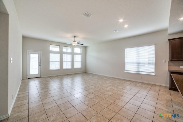 2241 Windswept Way, New Braunfels, TX 78132 - unfurnished living room with light tile patterned flooring, ceiling fan, and baseboards