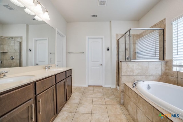 2241 Windswept Way, New Braunfels, TX 78132 - full bathroom with a shower stall, a bath, double vanity, and tile patterned flooring