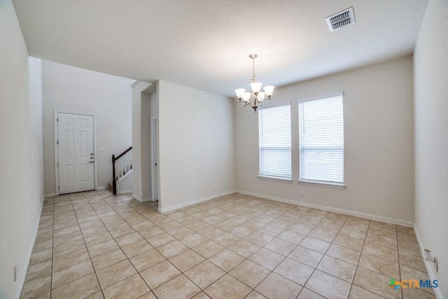 2241 Windswept Way, New Braunfels, TX 78132 - empty room with a chandelier, light tile patterned floors, and stairway
