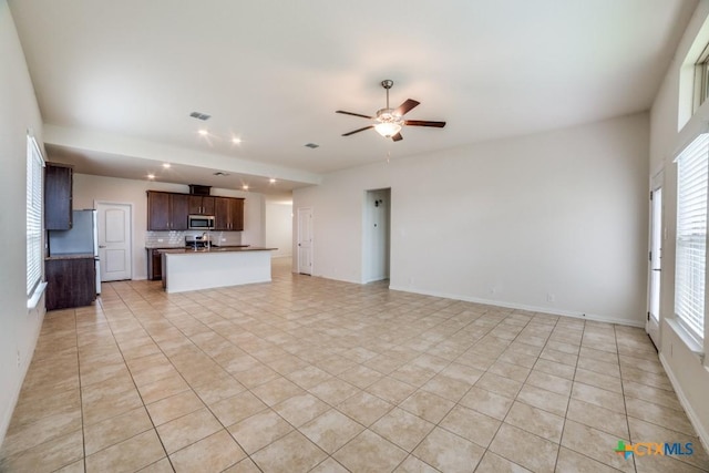 2241 Windswept Way, New Braunfels, TX 78132 - unfurnished living room featuring ceiling fan, light tile patterned floors, and recessed lighting