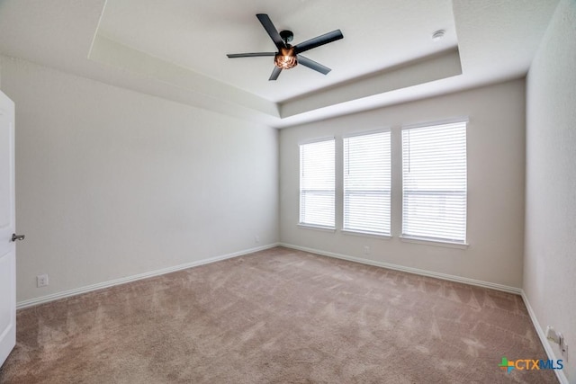 2241 Windswept Way, New Braunfels, TX 78132 - carpeted empty room featuring a tray ceiling, a ceiling fan, and baseboards