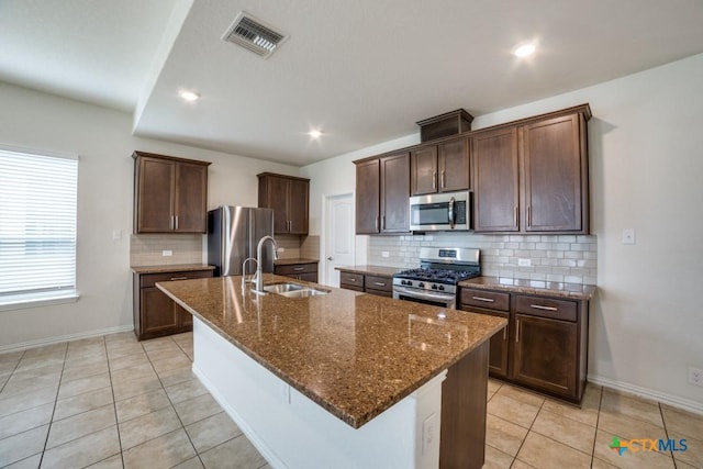 2241 Windswept Way, New Braunfels, TX 78132 - kitchen featuring appliances with stainless steel finishes, a sink, baseboards, light tile patterned flooring, and recessed lighting
