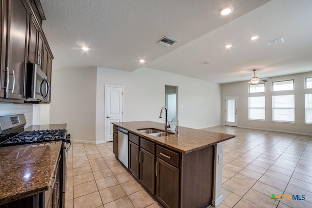 2241 Windswept Way, New Braunfels, TX 78132 - kitchen featuring appliances with stainless steel finishes, a sink, ceiling fan, light tile patterned flooring, and dark brown cabinetry