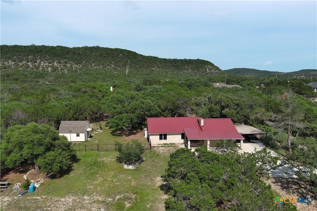1143 Flaman Rd, Canyon Lake, TX 78133 - aerial view of property and surrounding area featuring a heavily wooded area and a mountainous background