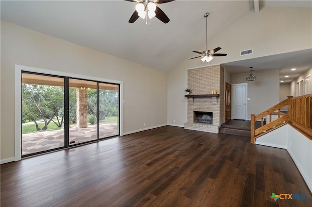 1143 Flaman Rd, Canyon Lake, TX 78133 - unfurnished living room featuring a ceiling fan, high vaulted ceiling, wood finished floors, beamed ceiling, and a fireplace