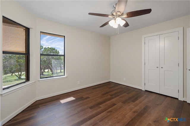1143 Flaman Rd, Canyon Lake, TX 78133 - unfurnished bedroom featuring dark wood-style floors, ceiling fan, and a closet