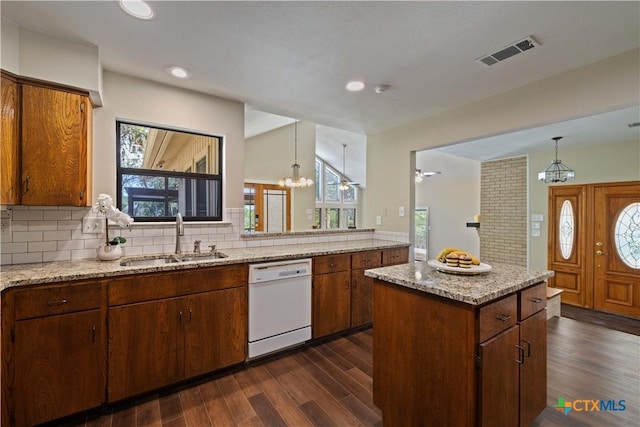1143 Flaman Rd, Canyon Lake, TX 78133 - kitchen with white dishwasher, dark wood finished floors, tasteful backsplash, a chandelier, and recessed lighting