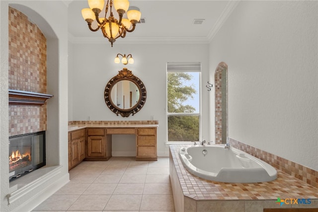 bathroom with vanity, tile patterned floors, a chandelier, a garden tub, and a tile fireplace
