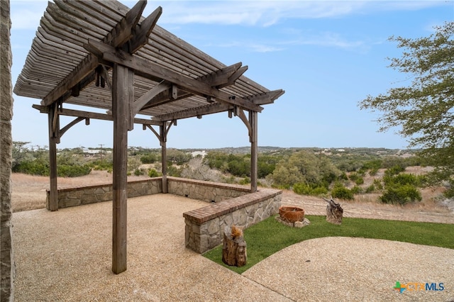 view of community with a pergola and a patio area