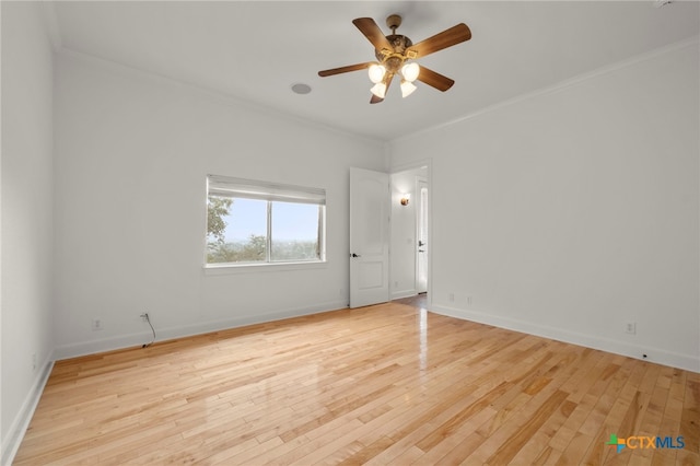 empty room featuring light wood finished floors, baseboards, a ceiling fan, and ornamental molding
