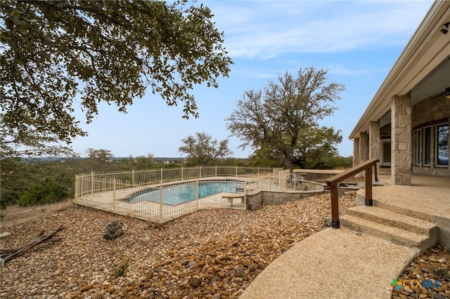view of pool with a patio area, a fenced in pool, and fence
