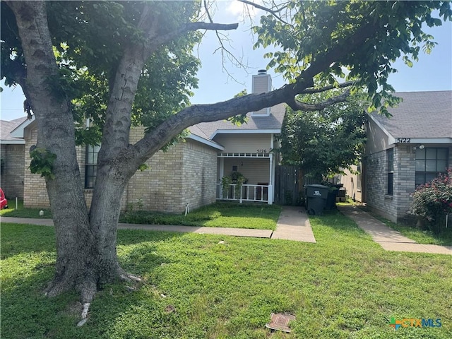 5126 Colonel Travis St, Temple, TX 76502 - view of side of home featuring a chimney and brick siding